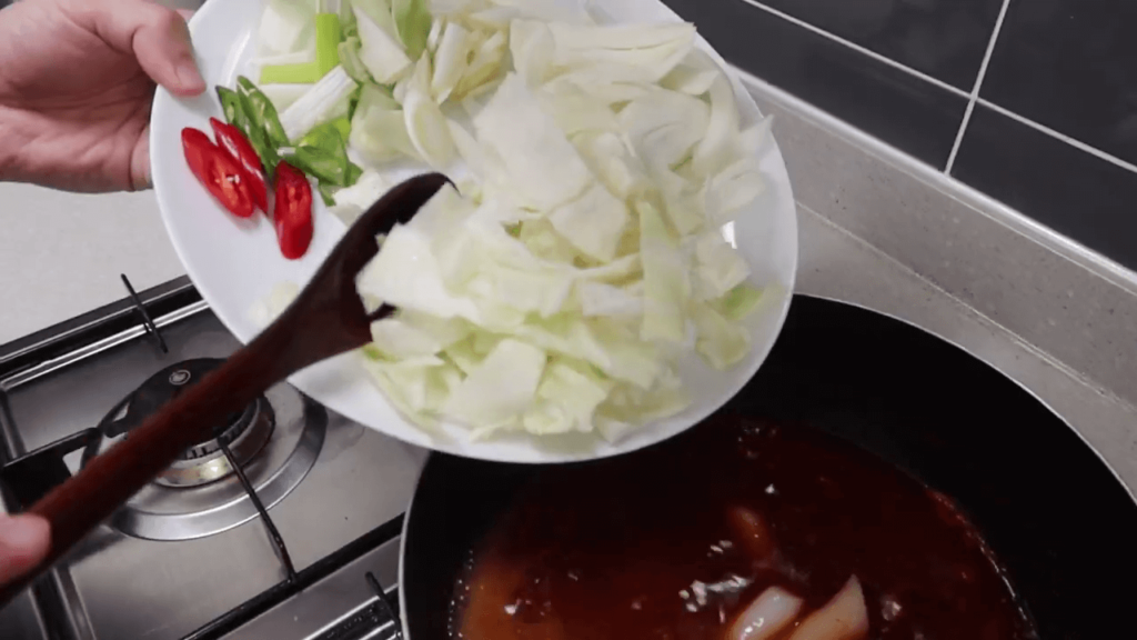 adding ingredients to the pot
