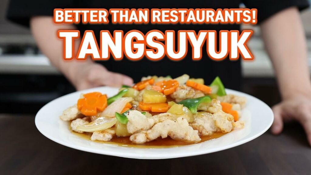 sweet and sour pork with vegetables on top