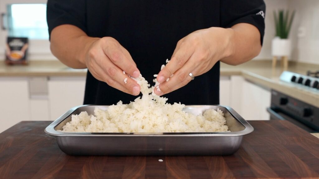Crumble leftover rice with hands