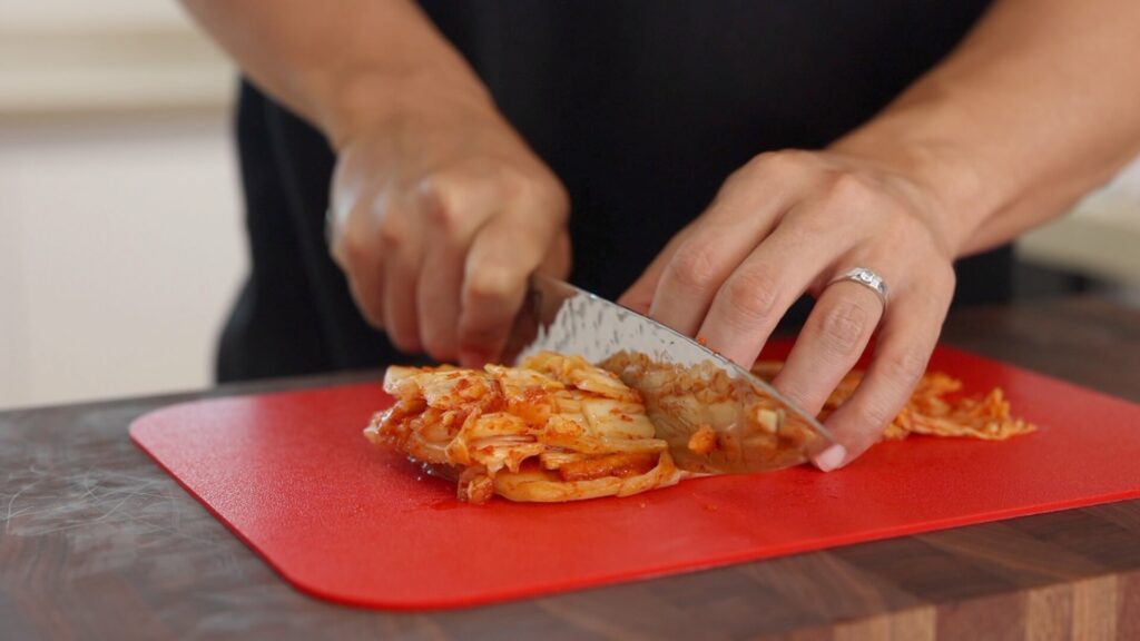 Chop kimchi on a cutting board