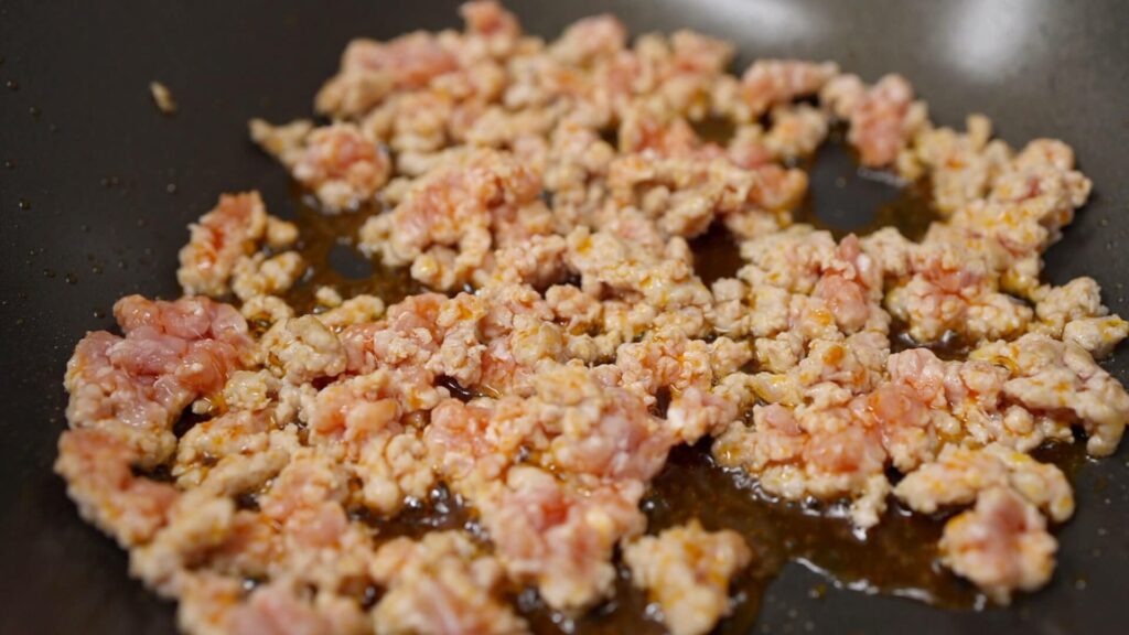 Cook ground pork with chili oil