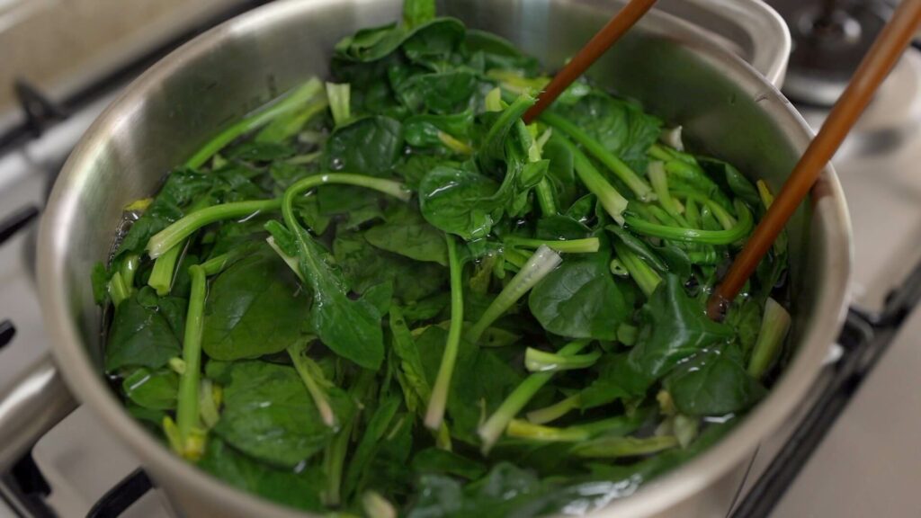 Blanch spinach in a pot