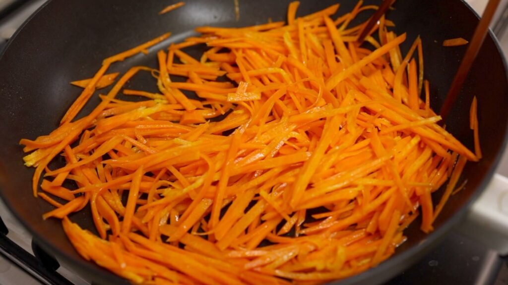 Cook julienned carrot 