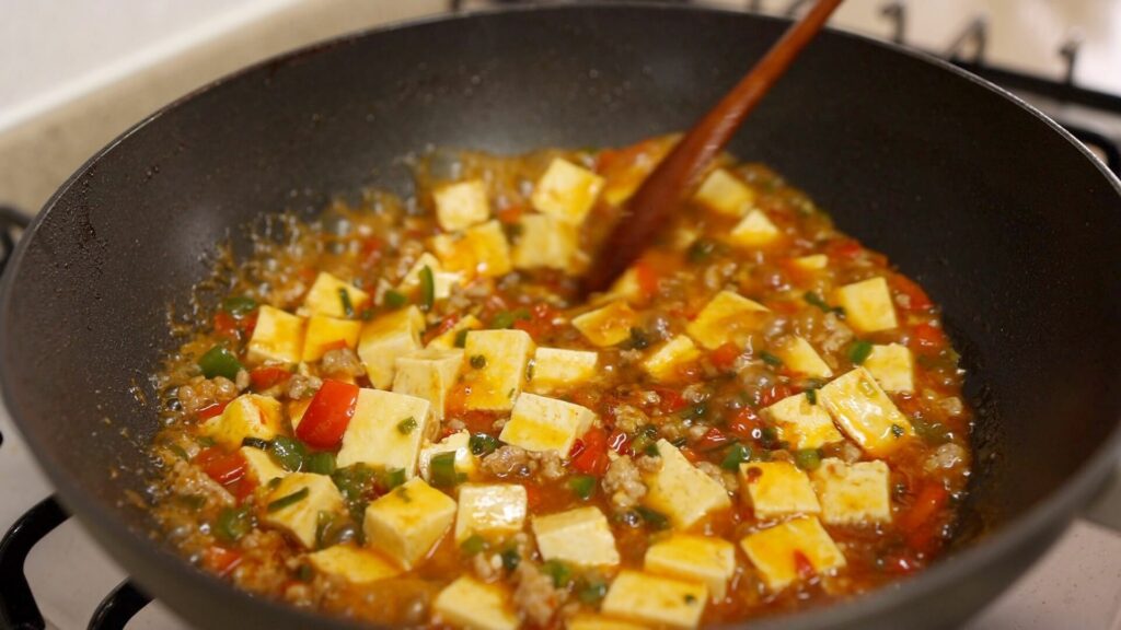 Cook mapo tofu in a wok
