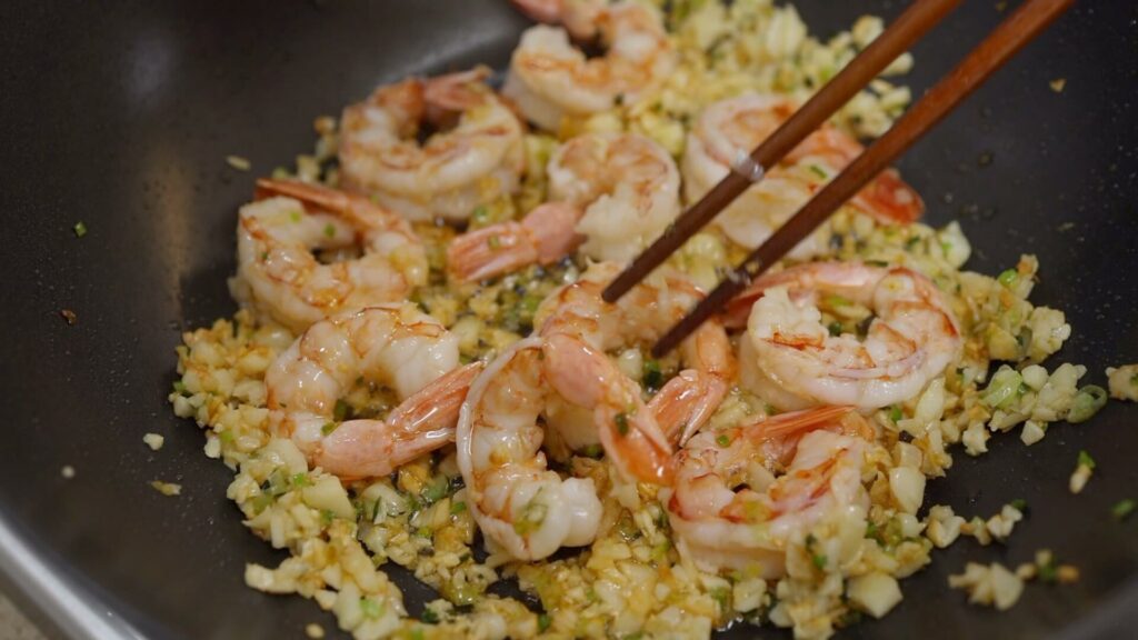 Cook garlic and shrimp in a pan