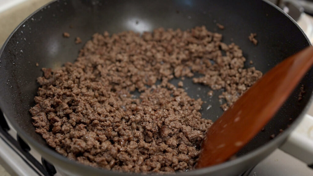 Cook ground beef in a wok