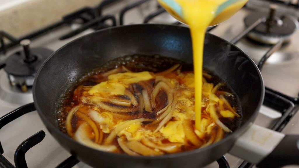 Pour beaten egg into a pan