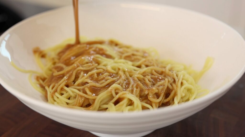 Toss the noodles in a tantanmen sauce