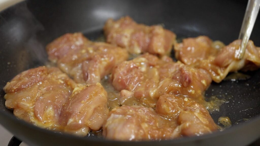 Cook doenjang marinated chicken in a pan