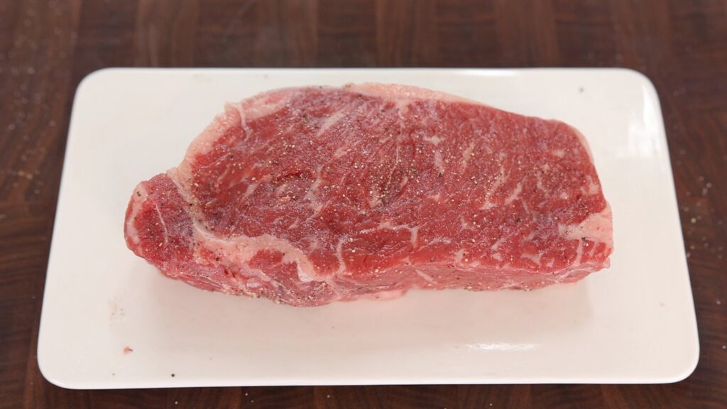 Season Steak with Salt and Pepper