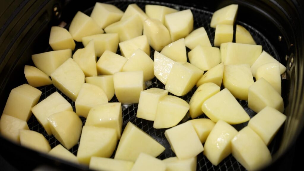 Potatoes in an air fryer basket
